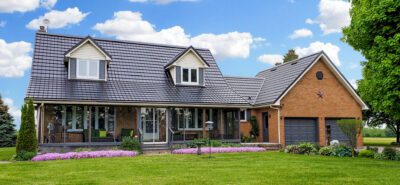 Hy-Grade-Steel-Roofing-System-Metal-Roofing-See-Our-Work-Slate-Grey-large green grass-2-story-home-with-red-brown-bricks