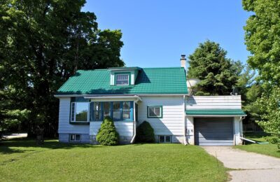 Hy-Grade-Steel-Roofing-System-Metal-Roofing-See-Our-Work-Hunter's-Green-green-yard- white-panel-siding-front-porch