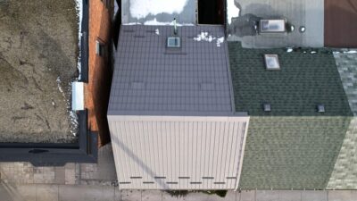 Hy-Grade-Steel-Roofing-System-Metal-Roofing-See-Our-Work-Slate-Grey-drone-footage - roof- in-Ontario- house-connected-to-dark-grey-asphalt-roof