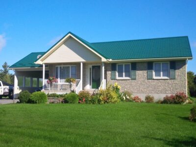 Hy-Grade-Steel-Roofing-System-Metal-Roofing-See-Our-Work-Hunter's-Green-green-yard- white-brick-siding-bungalow