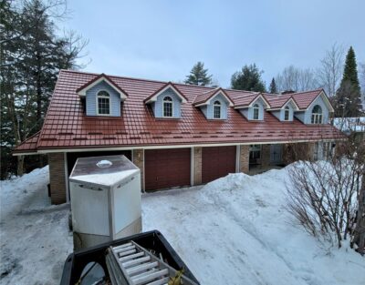 Hy-Grade-Steel-Roofing-System-Metal-Roofing-See-Our-Work-Canners-Brown-metal-roof-beige-siding-red-garage-doors