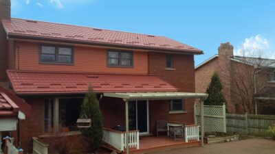 Hy-Grade-Steel-Roofing-System-Metal-Roofing-See-Our-Work-Canners-Brown-metal-roof-red-brown-brick-siding