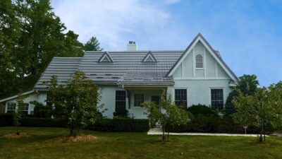 Hy-Grade-Steel-Roofing-System-Metal-Roofing-See-Our-Work-Charcoal-Grey-metal-roof-rural-home-blue-sky-green-grass-in-front-of-home