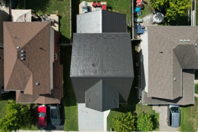 A Hy-Grade steel roof from a bird's eye view can be seen with green grass in the back and front yard.