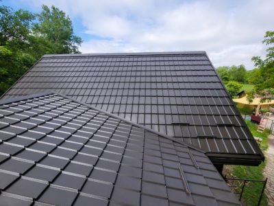 Top-of-roof photos of home with Hy-Grade metal roof in dark brown. Snow guards along bottom of roof.