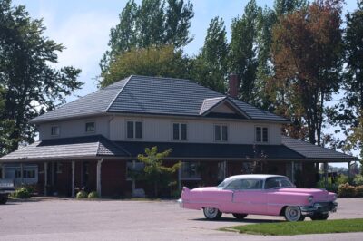 Hy-Grade-Steel-Roofing-System-Metal-Roofing-See-Our-Work-Slate-Grey-wooded-area-old-pink-car-in-foreground