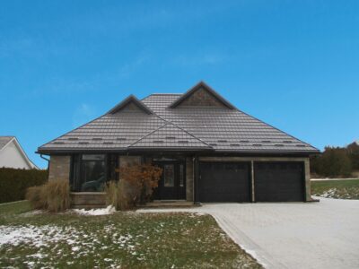 Hy-Grade-Steel-Roofing-System-Metal-Roofing-See-Our-Work-Charcoal-Grey-metal-roof-rural-home-blue-sky-green-grass-in-front-of-home