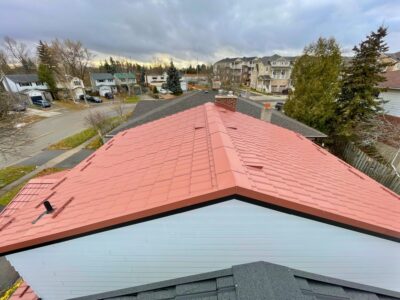 Hy-Grade-Steel-Roofing-System-Metal-Roofing-See-Our-Work-Canners-Brown-metal-roof-white-siding-on top of roof-angle