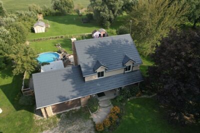 Hy-Grade-Steel-Roofing-System-Metal-Roofing-See-Our-Work-Slate-Grey-yellow brick home-gravel driveway-pool in backyard-2-story-home.