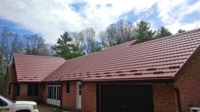 Hy-Grade-Steel-Roofing-System-Metal-Roofing-See-Our-Work-Canners-Brown-metal-roof-red-brick-siding
