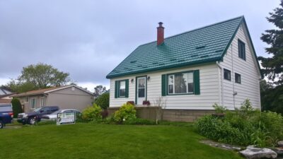 Hy-Grade-Steel-Roofing-System-Metal-Roofing-See-Our-Work-Hunter's-Green-green-yard- white-panel-siding-front-yard