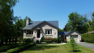 Hy-Grade-Steel-Roofing-System-Metal-Roofing-See-Our-Work-Slate-Grey-stone home-green-grass-cottage-bungalow-home