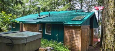 Hy-Grade-Steel-Roofing-System-Metal-Roofing-See-Our-Work-Hunter's-Green-hot tub-green-wood-2-skylights-siding-front-porch