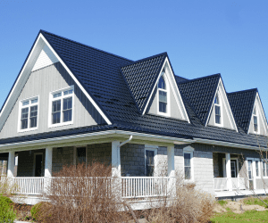 House with a Black Hy-Grade Steel roof in a sunny day with blue sky.