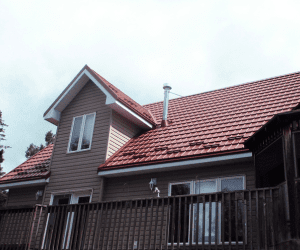 Hy-Grade-Steel-Roofing-System-Metal-Roofing-See-Our-Work-Canners-Brown-metal-roof-beige-red-siding